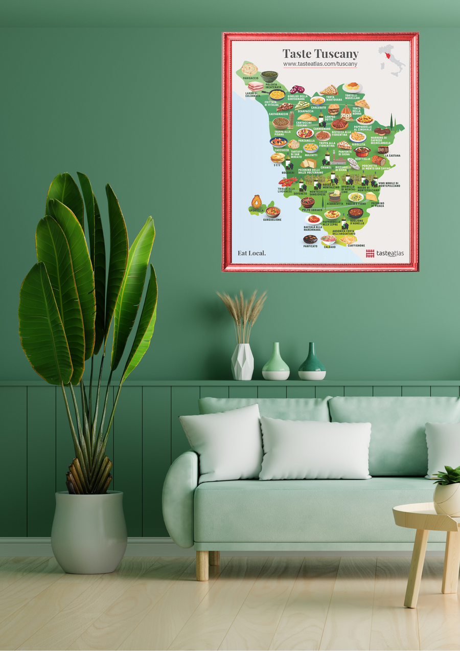 Taste Tuscany poster is hanging on a green wall in a living room, above green sofa