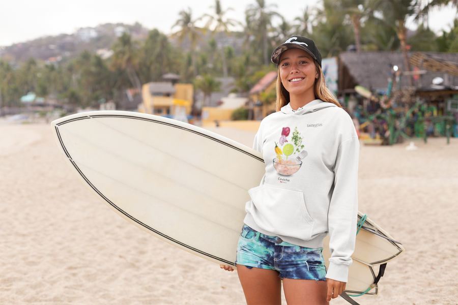 woman with a surfboard on a beach wearing ceviche hoodie