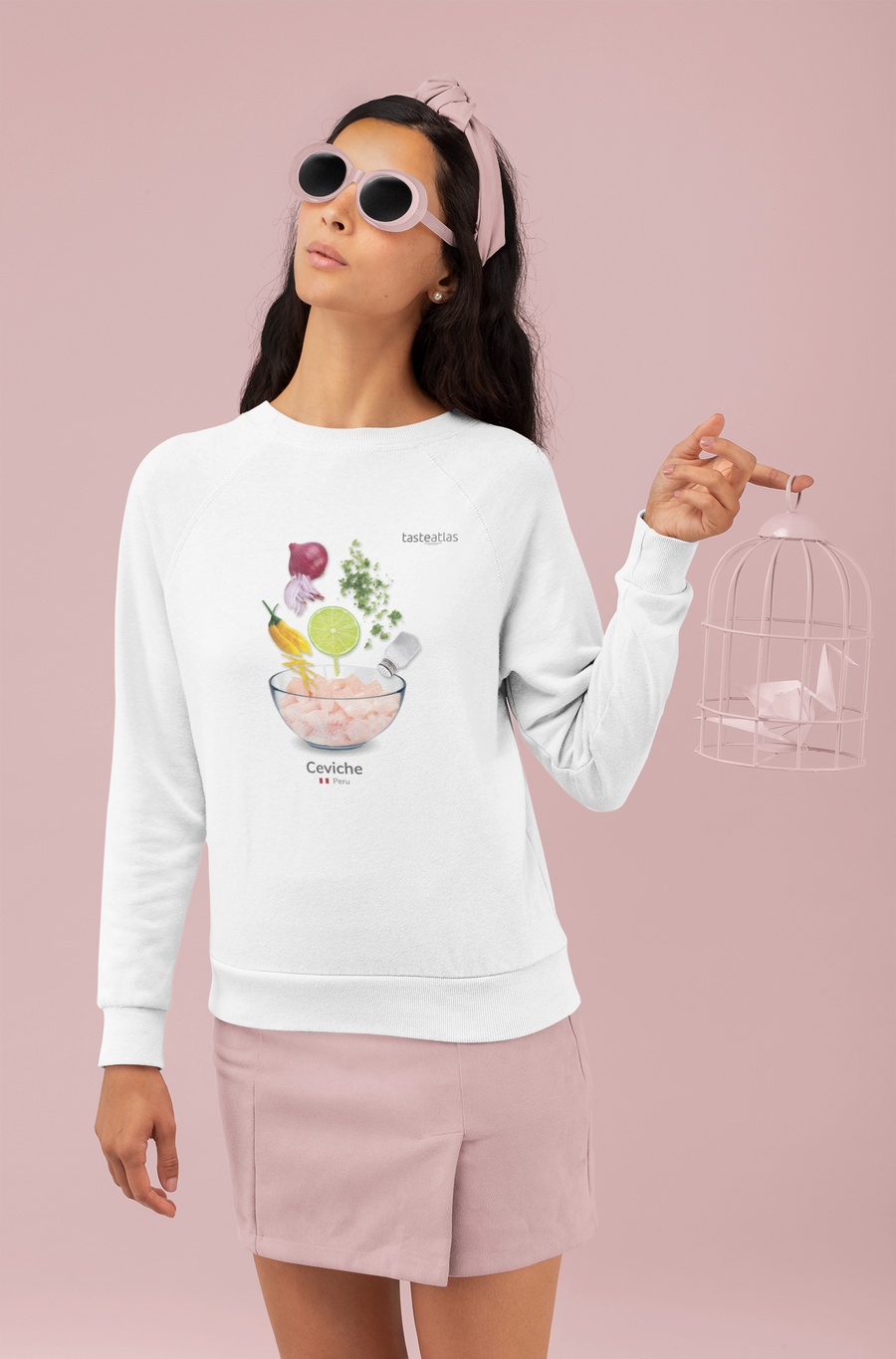 woman wearing ceviche sweatshirt in front of a pink wall