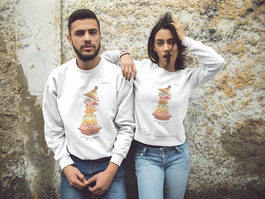 a couple by the wall wearing chicken tajine sweatshirts