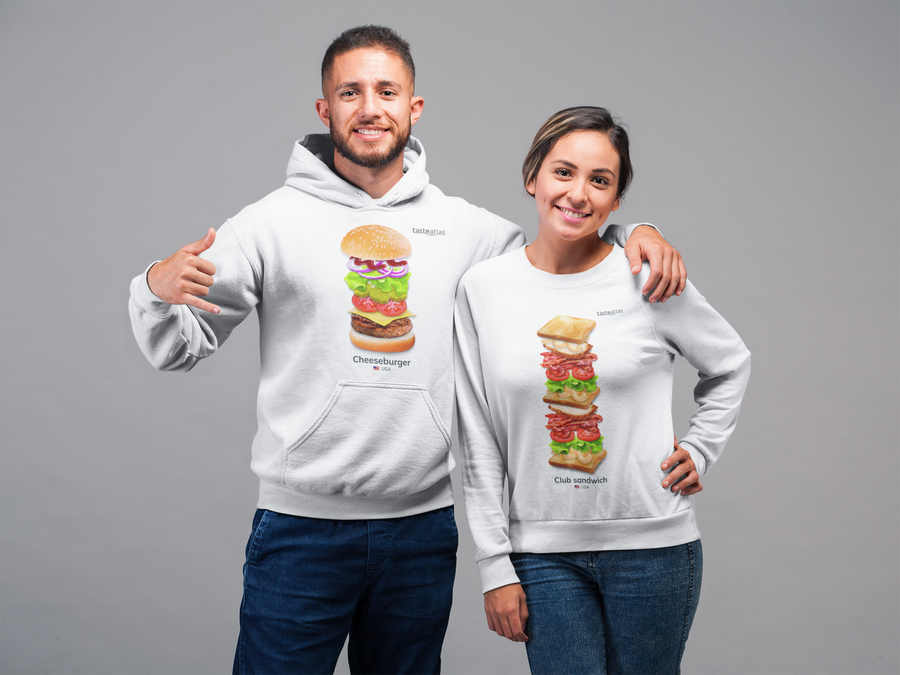 woman wearing club sandwich sweatshirt being hugged by a man