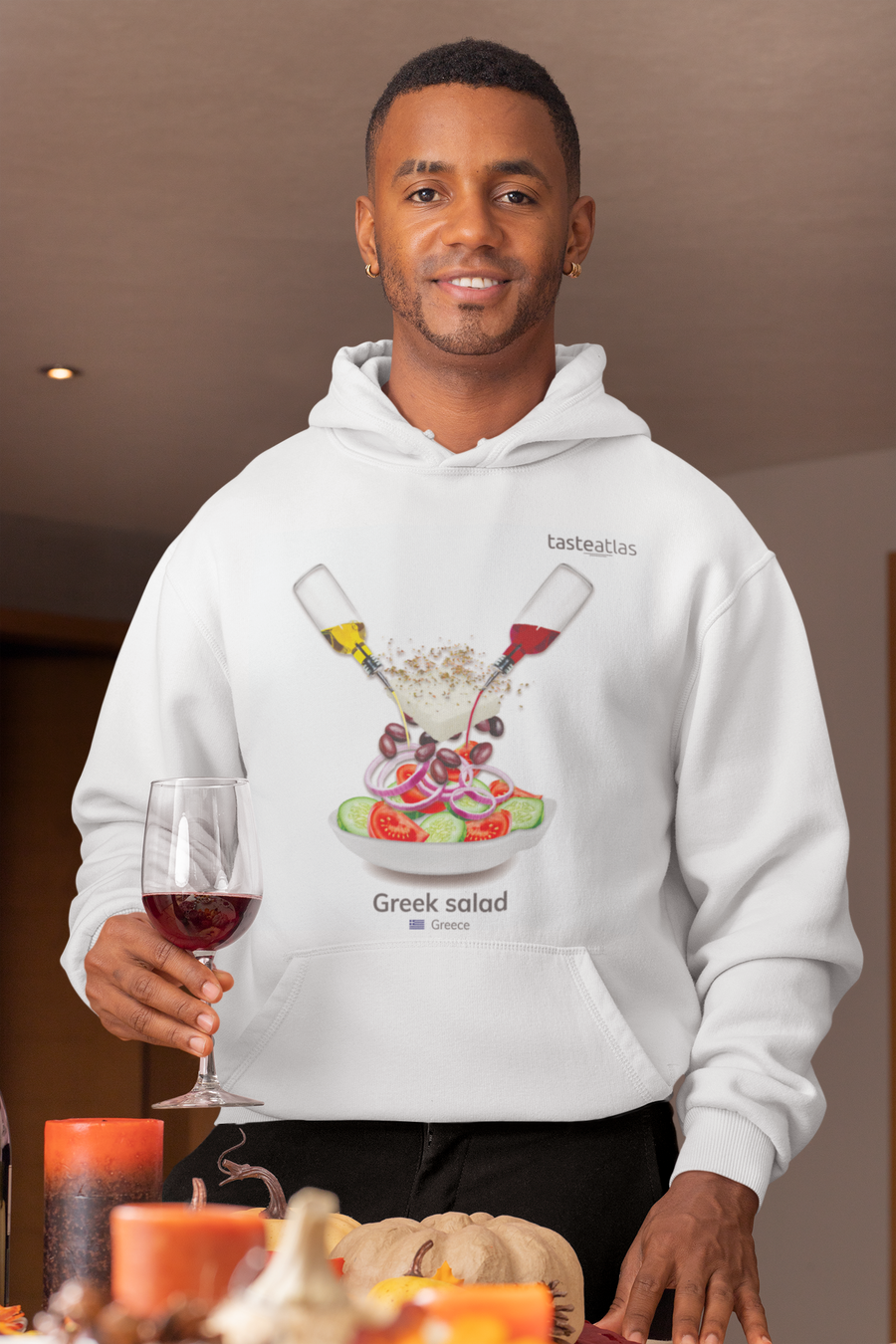 a man with a glass of wine wearing greek salad hoodie