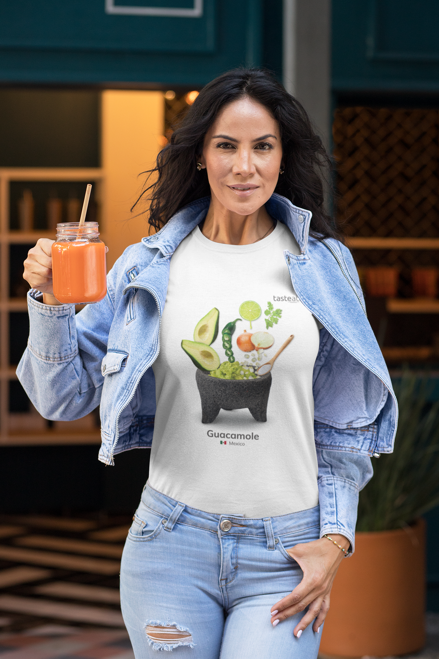woman holding a glass of juice wearing guacamole t-shirt