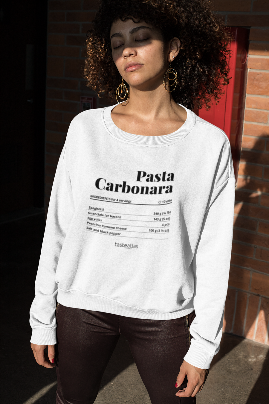 a woman in the sunshine wearing pasta carbonara recipe sweatshirt
